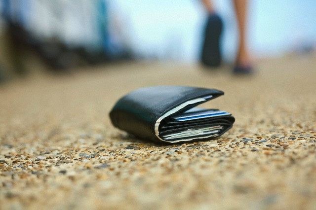 Lost wallet --- Image by © Seb Oliver/Image Source/Corbis