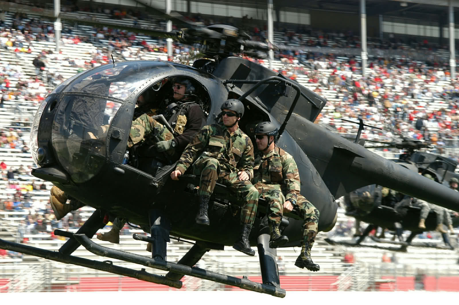 Four Special Operations warriors enter the Atlanta Motor Speedway aboard a MH-6 Little Bird helicopter during pre-race activities at the Kobalt Tools 500 at Atlanta Motor Speedway Mar. 18.  (Photo by Bonita Riddley, USASOC PAO)